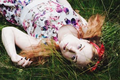 Young woman lying on grass