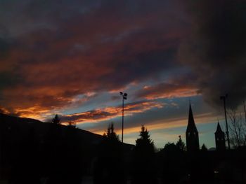 Low angle view of silhouette trees against sky at sunset