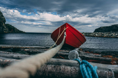 Rope tied to boat in sea against sky