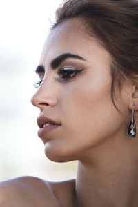 Close-up portrait of young woman looking away