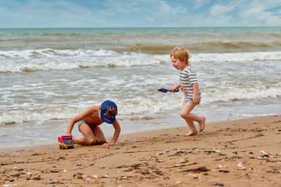 Full length of boy playing at beach