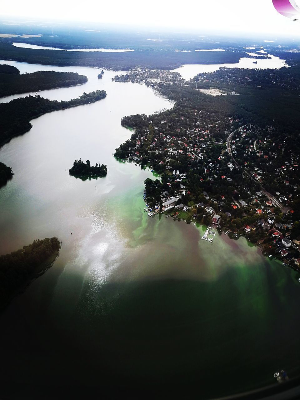 HIGH ANGLE VIEW OF SEA AND CITY AGAINST SKY