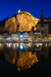 Reflection of illuminated buildings in lake at night