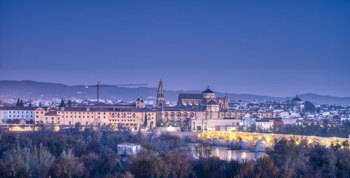 Buildings in city at dusk