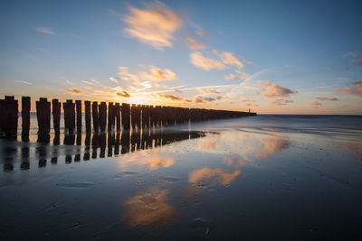 Scenic view of beach against sky during sunset