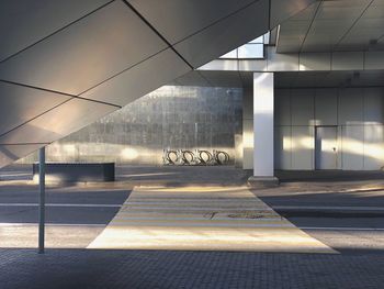 Empty road by building in city