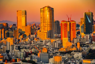 Aerial view of modern buildings in city against sky