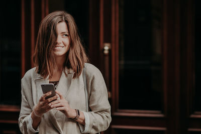 Full length of woman using mobile phone