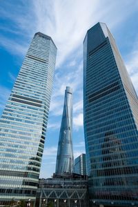 Low angle view of buildings against cloudy sky