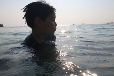 Portrait of boy swimming in sea