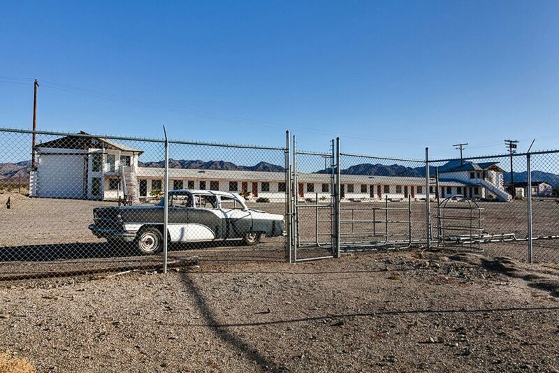 clear sky, built structure, architecture, transportation, building exterior, blue, railroad track, copy space, rail transportation, industry, public transportation, train - vehicle, sunlight, day, mode of transport, railroad station platform, outdoors, railroad station, no people, sky