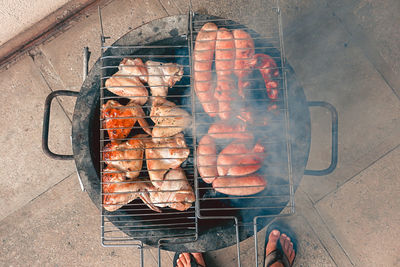 Directly above shot of meat on barbecue grill