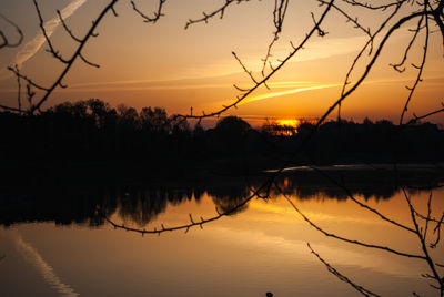 Scenic view of lake against orange sky