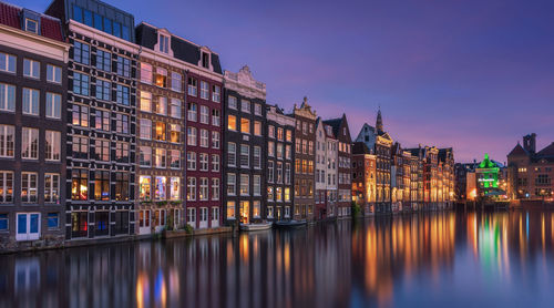 Reflection of buildings in city at night amsterdam 