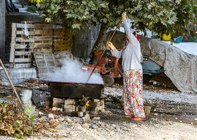 Woman preparing food in yard