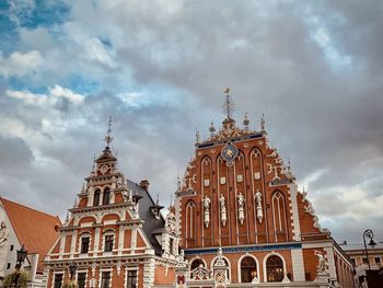 Low angle view of temple building against cloudy sky