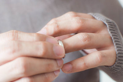Close-up of woman holding wedding ring
