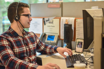 Young man using computer at office