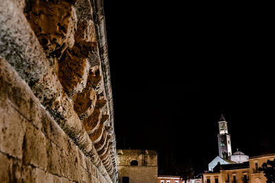 Low angle view of old building against sky at night