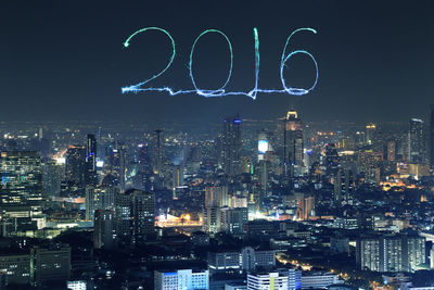 Illuminated city against sky at night