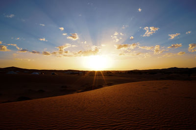 Scenic view of desert against sky during sunset