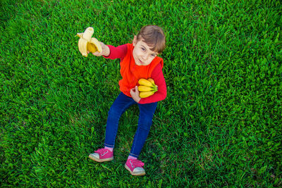 Full length of boy standing on grassy field