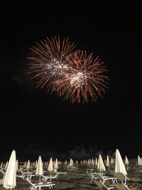 Low angle view of firework display at night