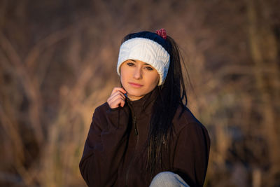 Portrait of beautiful young woman wearing hat