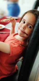 Portrait of smiling girl holding camera