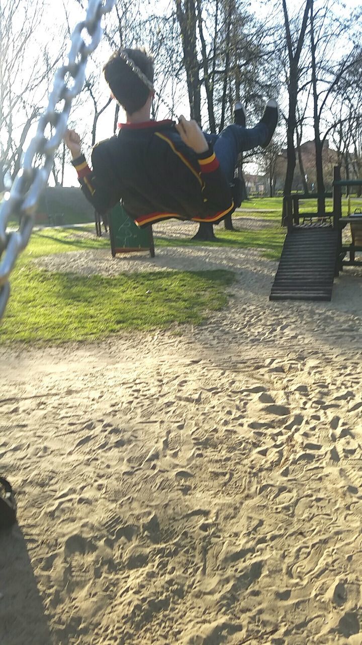 real people, full length, childhood, motion, tree, lifestyles, day, boys, leisure activity, outdoors, fun, nature, men, mid-air, playing, grass, people