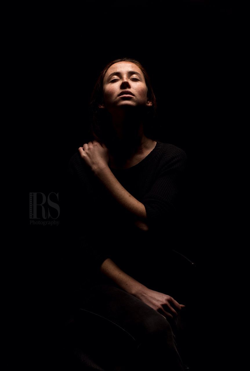 studio shot, one person, adults only, black background, social issues, people, adult, indoors, portrait