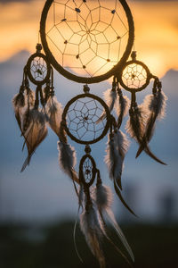 Close-up of feather hanging against sky