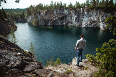 Rear view of man looking at waterfall