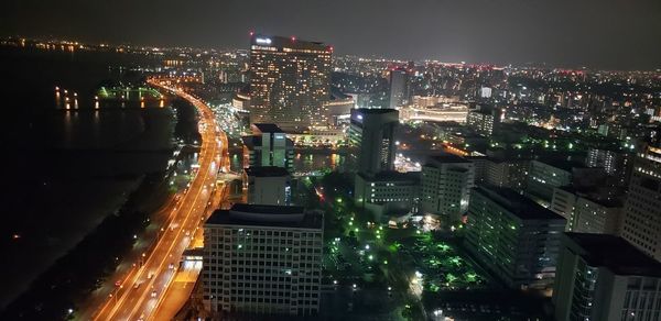 High angle view of illuminated buildings in city at night