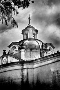 Low angle view of building against cloudy sky