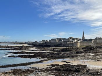Buildings on beach against sky