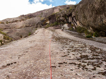 Road leading towards mountain against sky