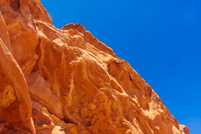 Close-up of rock against clear blue sky