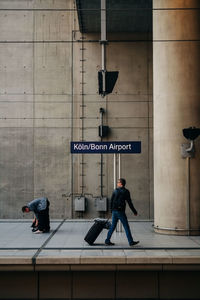 Men walking on wall