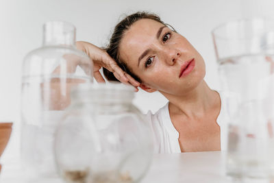 Portrait of young woman drinking water