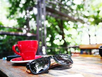 Close-up of tea cup and sunglasses on table