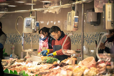 Friends standing at market stall