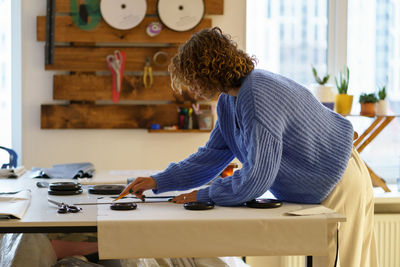 Side view of man working on table