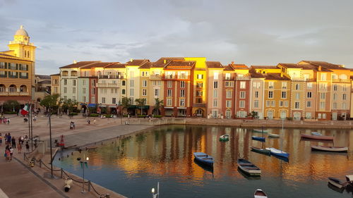 High angle view of boats on lake in city during sunset