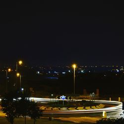 High angle view of illuminated buildings against sky at night