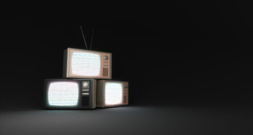 Close-up of camera against black background