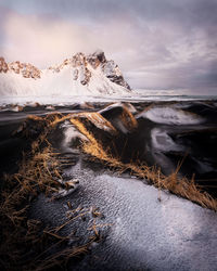 Scenic view of snowcapped mountains against sky during sunset