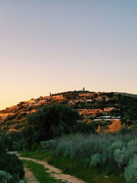 Scenic view of landscape against clear sky during sunset