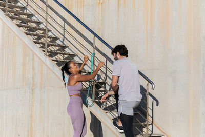 People standing on staircase against wall