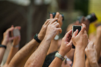 Cropped image of hands photographing